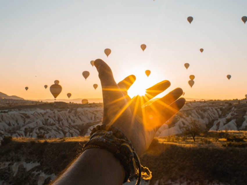 hand, sun, air balloons, mountains, sunrise