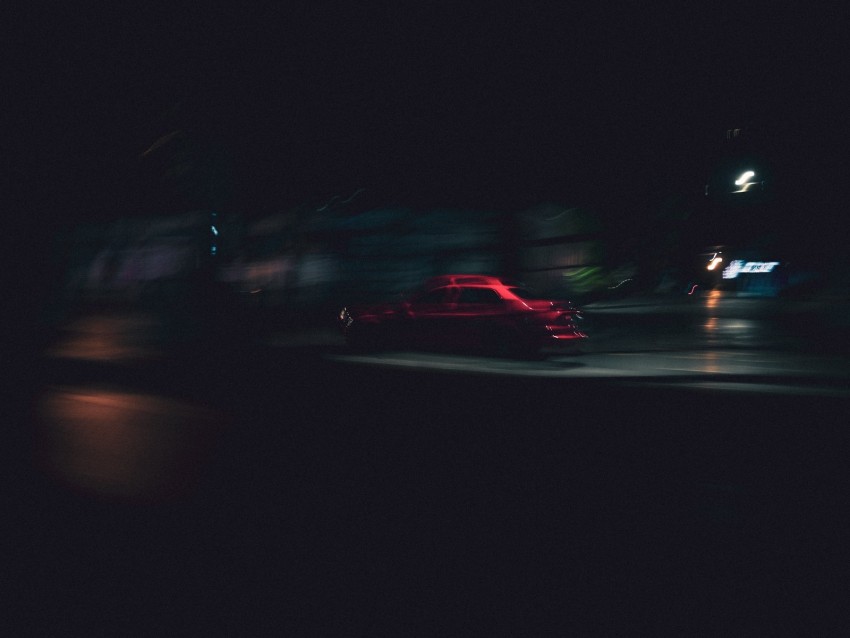 red car, night photography, motion blur, urban scene, street lights